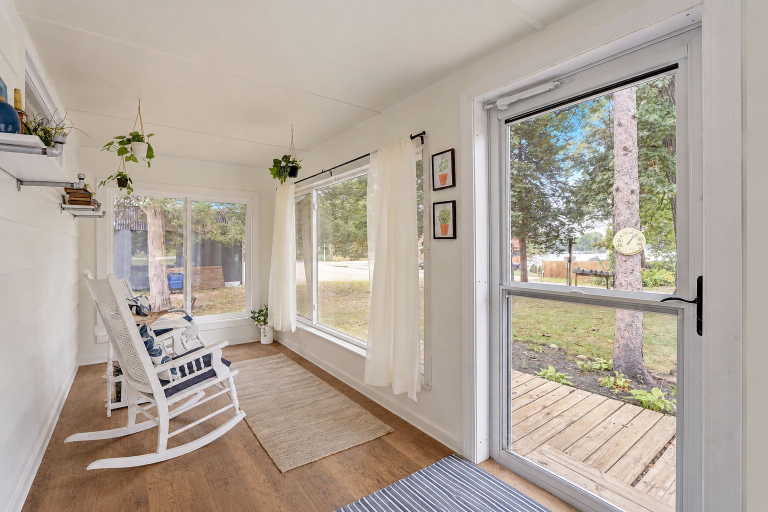Bright 3-season sunroom with rocking chairs, enjoy morning coffee and sunset views just steps from Little Green Lake.