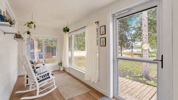 Bright 3-season sunroom with rocking chairs, enjoy morning coffee and sunset views just steps from Little Green Lake.