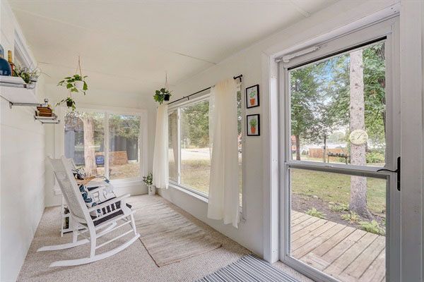 Bright 3-season sunroom with rocking chairs, enjoy morning coffee and sunset views just steps from Little Green Lake.