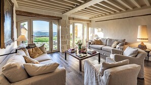 A spacious living room with a high ceiling, large windows, and a view of the countryside. - Promo Dernière Minute Magnifique (Beynac-et-Cazenac)