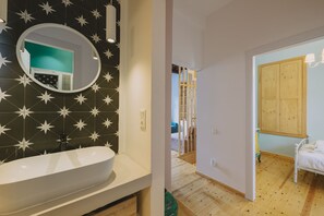 A bathroom with a star-patterned wall, a round mirror, and a white sink. - Minoos Residence, Central restored/modern 3floor house w/ seasonal roof pool (Rethymno)