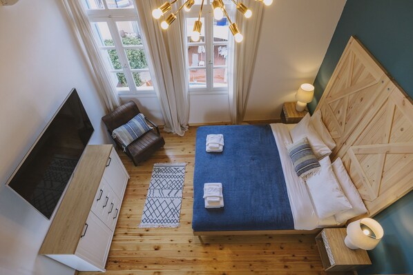 A bedroom with a bed, a TV, a wooden cabinet, and a window with curtains. - Minoos Residence, Central restored/modern 3floor house (Rethymno)