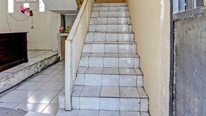 Een trap met witte tegels en een gele muur.