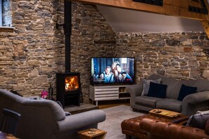 Relax in this inviting living room with a fireplace, flat-screen TV, and comfortable seating.