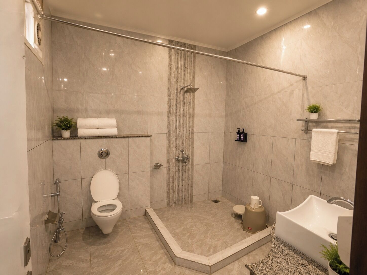 A modern bathroom with a shower, toilet, and bathtub.