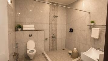 A modern bathroom with a shower, toilet, and bathtub.