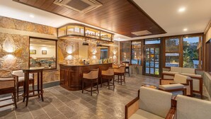 A bar area with stone walls, wooden ceiling, and seating. - Sarasiruham Resort - Private Pool Villa in Udaipur (Udaipur)