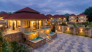 A resort with multiple buildings, outdoor pools, and stone pathways. - Sarasiruham Resort - Private Pool Villa in Udaipur (Udaipur)