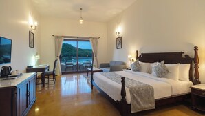 A spacious bedroom with a large bed, a desk, and a view of the outdoors. - Sarasiruham Resort - Private Pool Villa in Udaipur (Udaipur)
