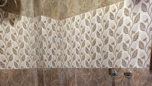 A bathroom with a toilet, a sink, and a shower area. - Roomshala 061 NK Residency (New Delhi)