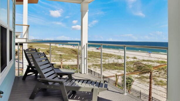 A balcony with two lounge chairs overlooking a beach. - Beachfront, Pet Friendly with 2 Decks~ Windsong (Mexico Beach)