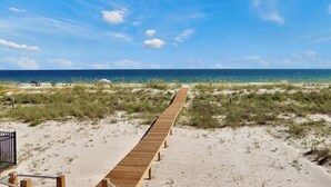 A wooden boardwalk leading to a beach with clear skies and ocean views. - Beachfront, Pet Friendly with 2 Decks~ Windsong (Mexico Beach)