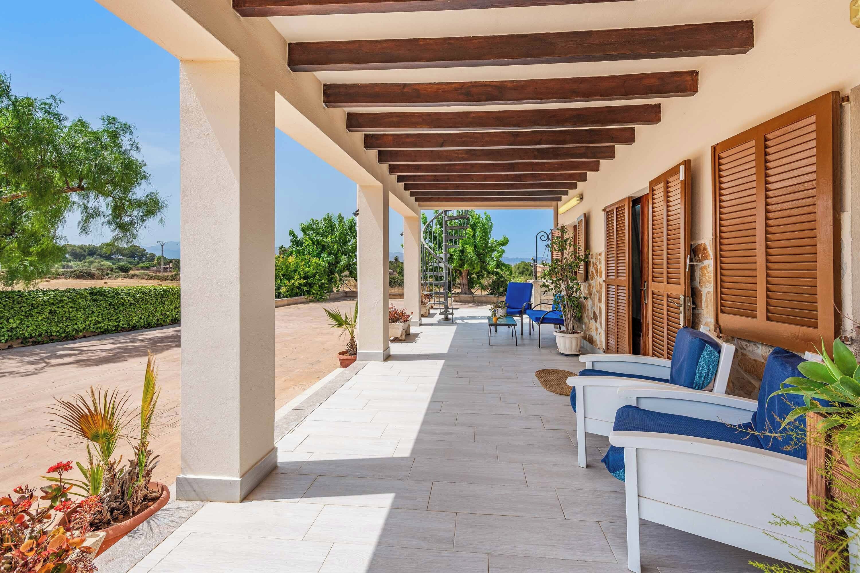 A covered outdoor seating area with a view of the landscape.