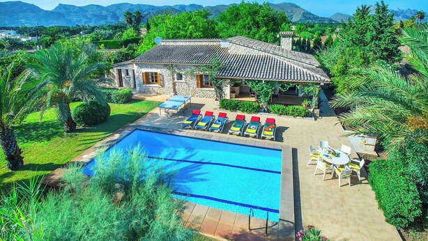 A villa with a swimming pool, outdoor seating, and a view of mountains. - Villa Tanca - Three Bedroom Villa, Sleeps 6 (El Vilà)
