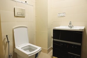 Deluxe Double Room | Bathroom | Shower, slippers, towels, soap - Roomshala 081 Manya Residency (New Delhi)