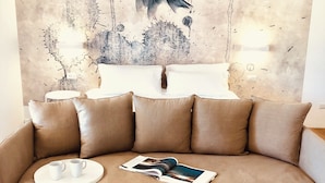 A beige sofa with a magazine and two white cups on a white tray. - Il Borgo Boutique rooms By Kasa Vacanze  (Loiri Porto San Paolo)