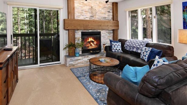 A cozy living room with a fireplace, a television, and a comfortable seating area.