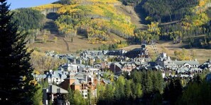 A town with a dense cluster of buildings, surrounded by forested hills. - Townsend Place 2 Bedroom Ski-in, Ski-out Condo in Beaver Creek Village (Avon)