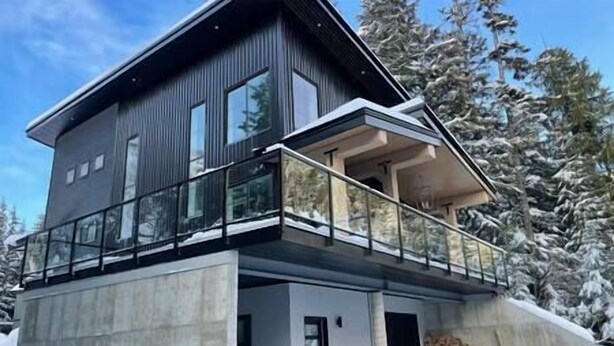A modern two-story house with a balcony and a garage. - Black Diamond Cabin | Private Hot Tub • Wood Fireplace • BBQ (Agassiz)