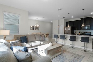 Enjoy a stylish living area with a sofa set and dining table, perfect for entertaining guests.