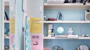 A neatly organized laundry room with shelves holding towels, a drying rack, and various cleaning supplies. - Romantic~Butterfly Cttg~Central Loc, Firepit ~Oaks (San Antonio)