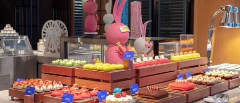 A dessert display with various cakes and pastries.