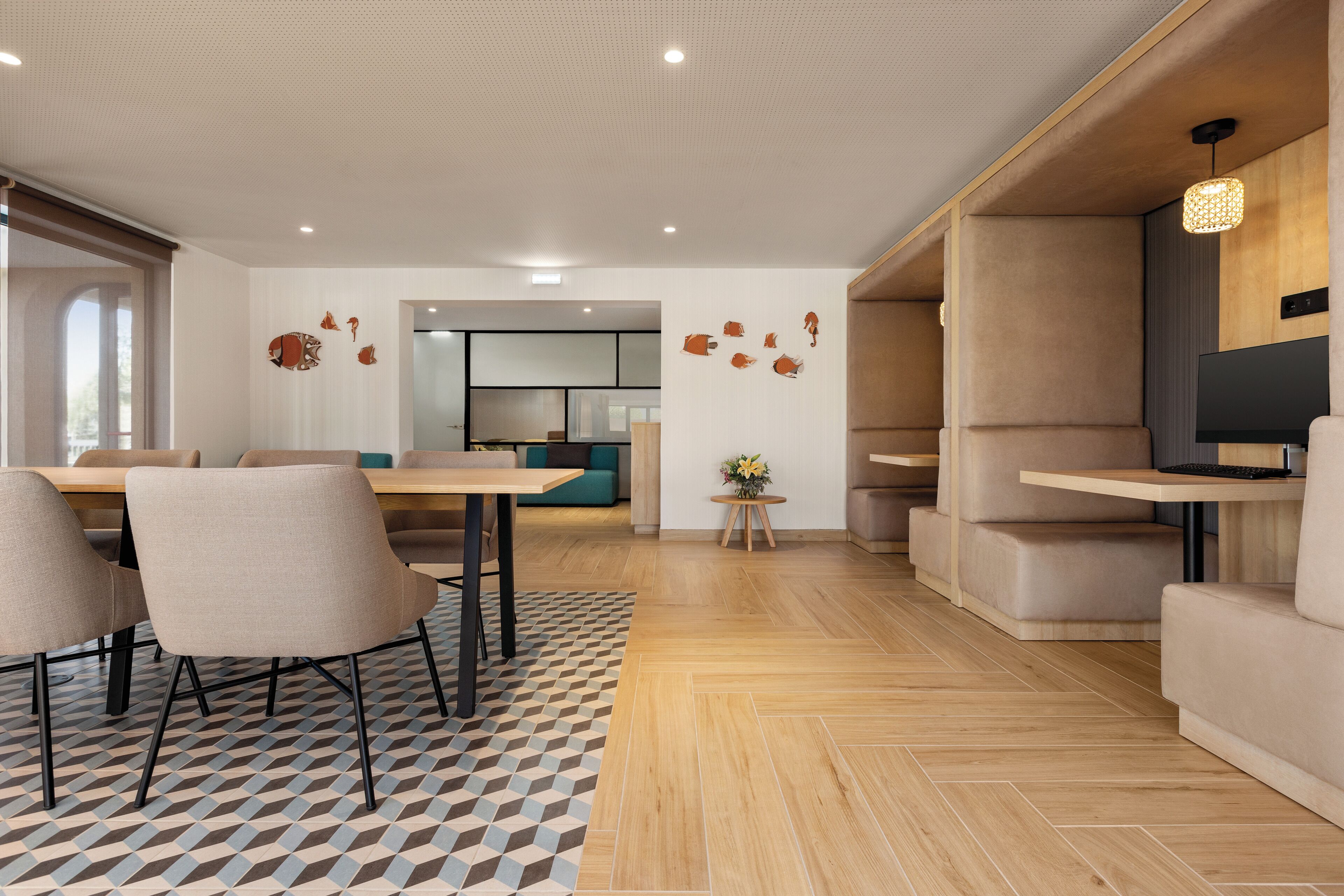 A modern living room with a dining area, a TV, and a kitchen in the background.