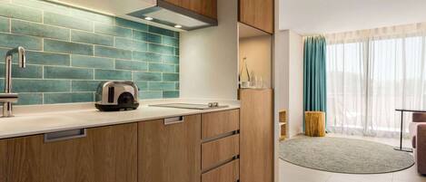 A modern kitchen with wooden cabinets, a tiled backsplash, and a built-in oven.