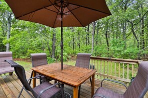 Relax on the deck with a view of the surrounding forest, where you can enjoy a meal or simply unwind.