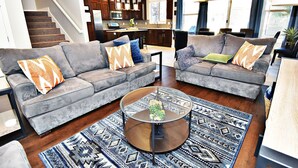 A modern living room with two grey sofas, a coffee table, and a patterned rug. - Entrada at Moab 420 and 424 and 428 (Moab)