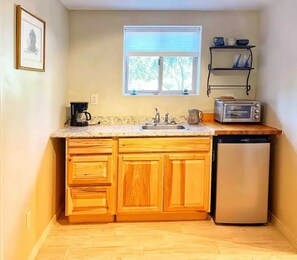 Fridge, microwave, coffee/tea maker, cookware/dishes/utensils