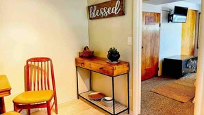 A dining area with a wooden chair, a small table, and a wall-mounted sign that reads "blessed." - Central & Peaceful Getaway at Cozy Studio Apt.  (Toquerville)