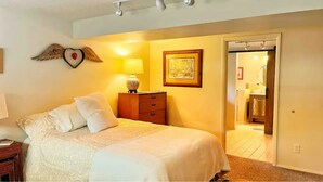 A bedroom with a bed, a nightstand, a lamp, a dresser, and a framed picture on the wall. - Central & Peaceful Getaway at Cozy Studio Apt.  (Toquerville)