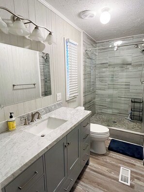 Shower, hair dryer, towels, toilet paper