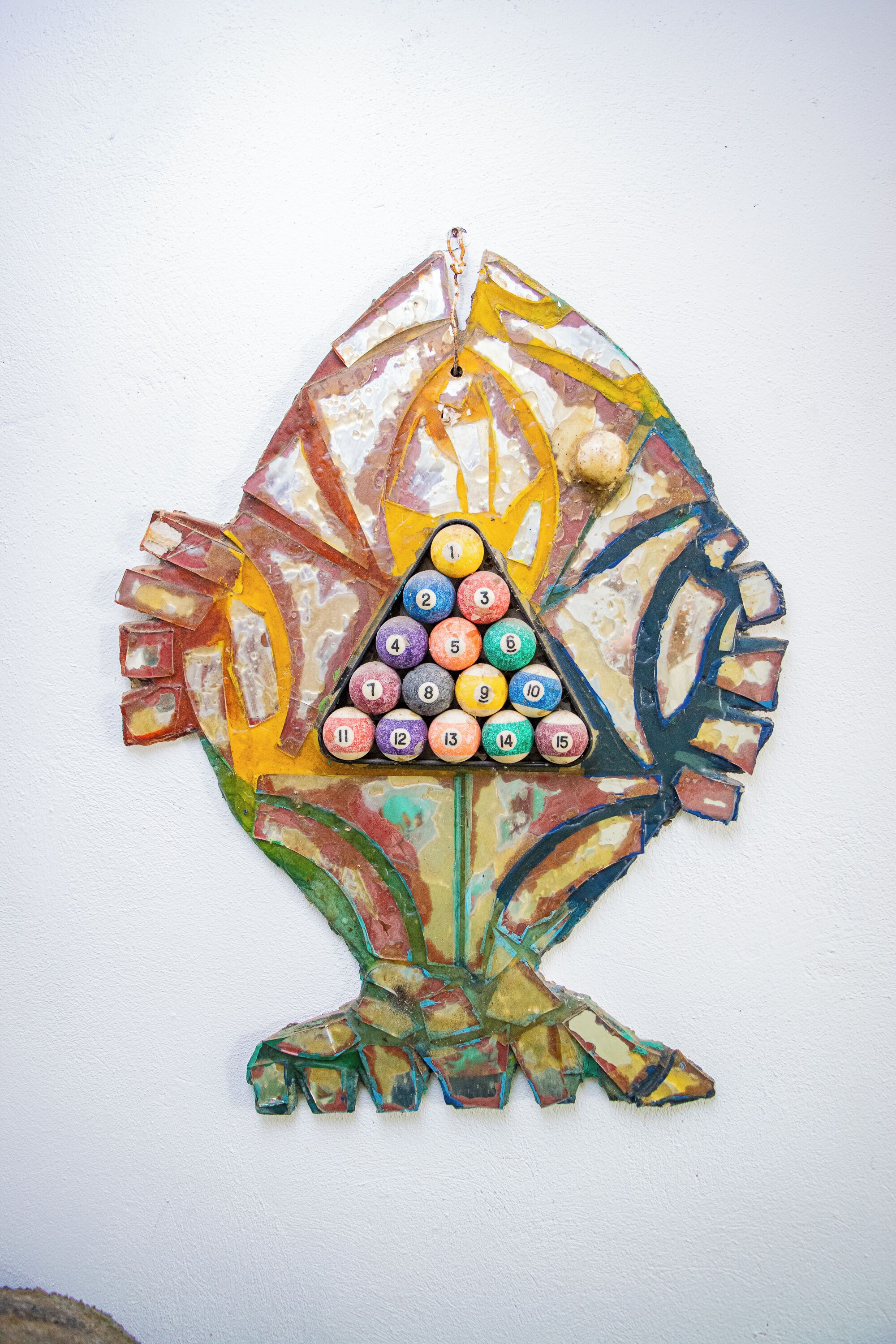A colorful, abstract art piece with a triangular pattern of numbered tiles.