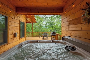 A wooden cabin with a hot tub, a deck, and a view of the forest. - Dream Mtn~Hot Tub+Fire Pit+Grill~Fireplace & WiFi! (Black Mountain)