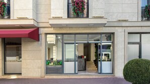 A modern building with large glass doors, a reception area, and potted plants on the balconies. - Lenus Hagia Sophia Hotel (Istanbul)