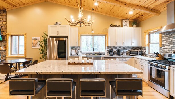 A spacious kitchen with a large island, modern appliances, and a rustic wooden ceiling. - SNOW BUNNY - Game Room - Hot Tub - Fire Pit (Big Bear Lake)