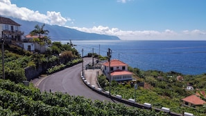 Une route côtière, avec des maisons d’un côté et la mer de l’autre.