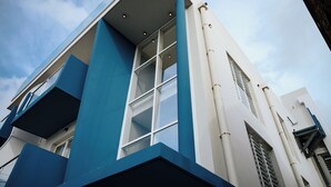 A modern building with a blue and white facade, large windows, and a flat roof. - SABLE BLEU BOUTIQUE HOTEL (Le Marin)