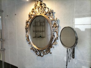 Two ornate mirrors with intricate designs on a tiled wall. - Ocean - Volcano House (Guatiza)