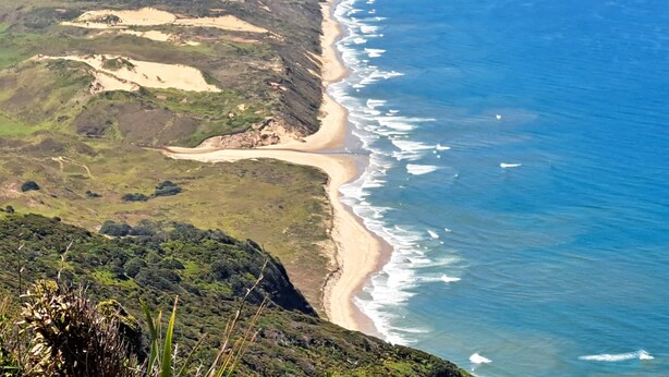 A coastal landscape with a beach and cliffs. - Comfort and the best seat in the west to view the Tasman Sea (Baylys Beach)