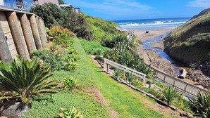 A coastal pathway with a wooden railing, leading to a beach. - Comfort and the best seat in the west to view the Tasman Sea (Baylys Beach)