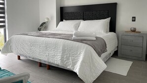 A modern bedroom with a large bed, a bedside table, and a nightstand. - Nice Apartment Perfect Location Ext View. (Ciudad de México)