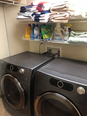 Convenient laundry facilities with two washing machines and storage for essentials.