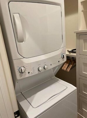 Convenient laundry facilities feature a washer and dryer unit with control panels.