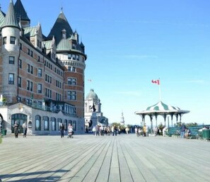A promenade with a castle-like building and a gazebo. - Stunning apartment in Saint-Roch (Québec)