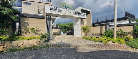 A modern building with a sign reading "Vista Hermosa" and a logo.