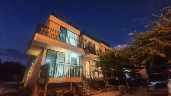 A multi-story building with balconies and staircases.