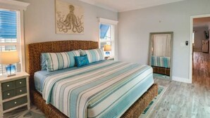 A bedroom with a large bed, a ceiling fan, and a painting on the wall. - New! Oceanview Oasis whole house - Theater - Screened Porch - Sundeck - Grill (Marathon)